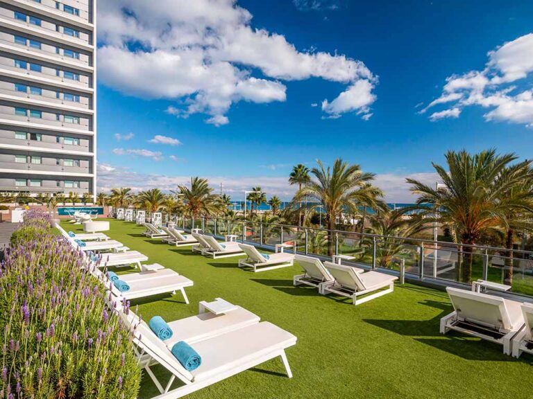 Sun loungers by the pool at Occidental Atenea Mar, perfect for enjoying the sunshine and poolside drinks.