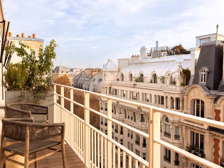 Balcony view from a guest room at Hotel Dame des Arts, overlooking the charming Parisian streets