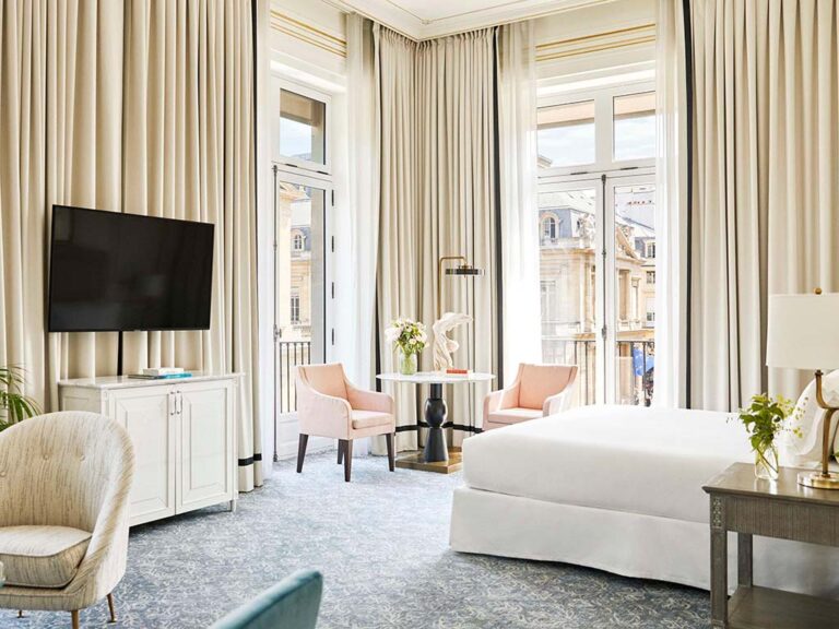 Spacious and modern guest room at Hotel du Louvre, with plush bedding and contemporary décor