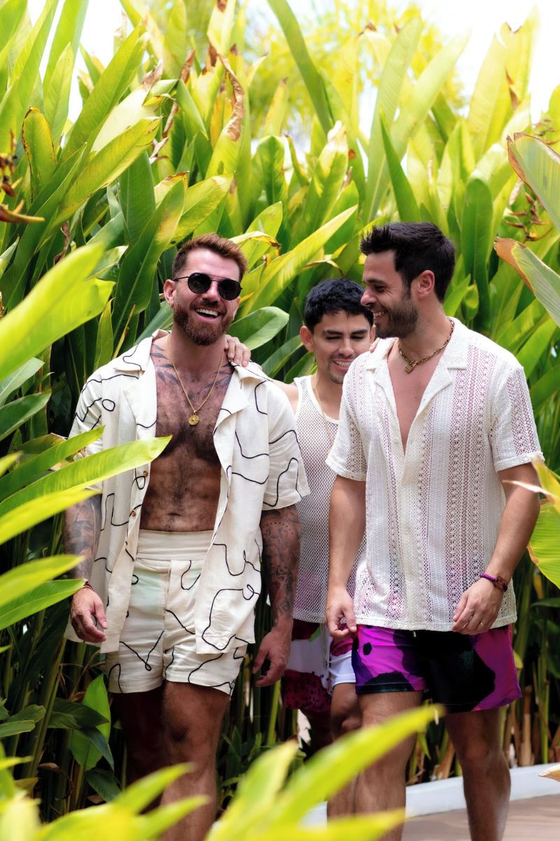 Three men in Puerto Vallarta, Mexico, surrounded by lush greenery.