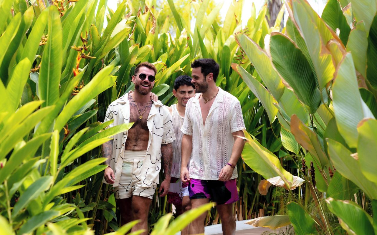 Three men in Puerto Vallarta, Mexico, surrounded by lush greenery.